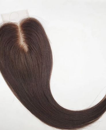 A brown hair wig or clip in topper with a visible center part, laid flat on a white surface. The smooth, straight hair tapers to a point at the end—ideal for seamlessly concealing hair loss with meshless integration.